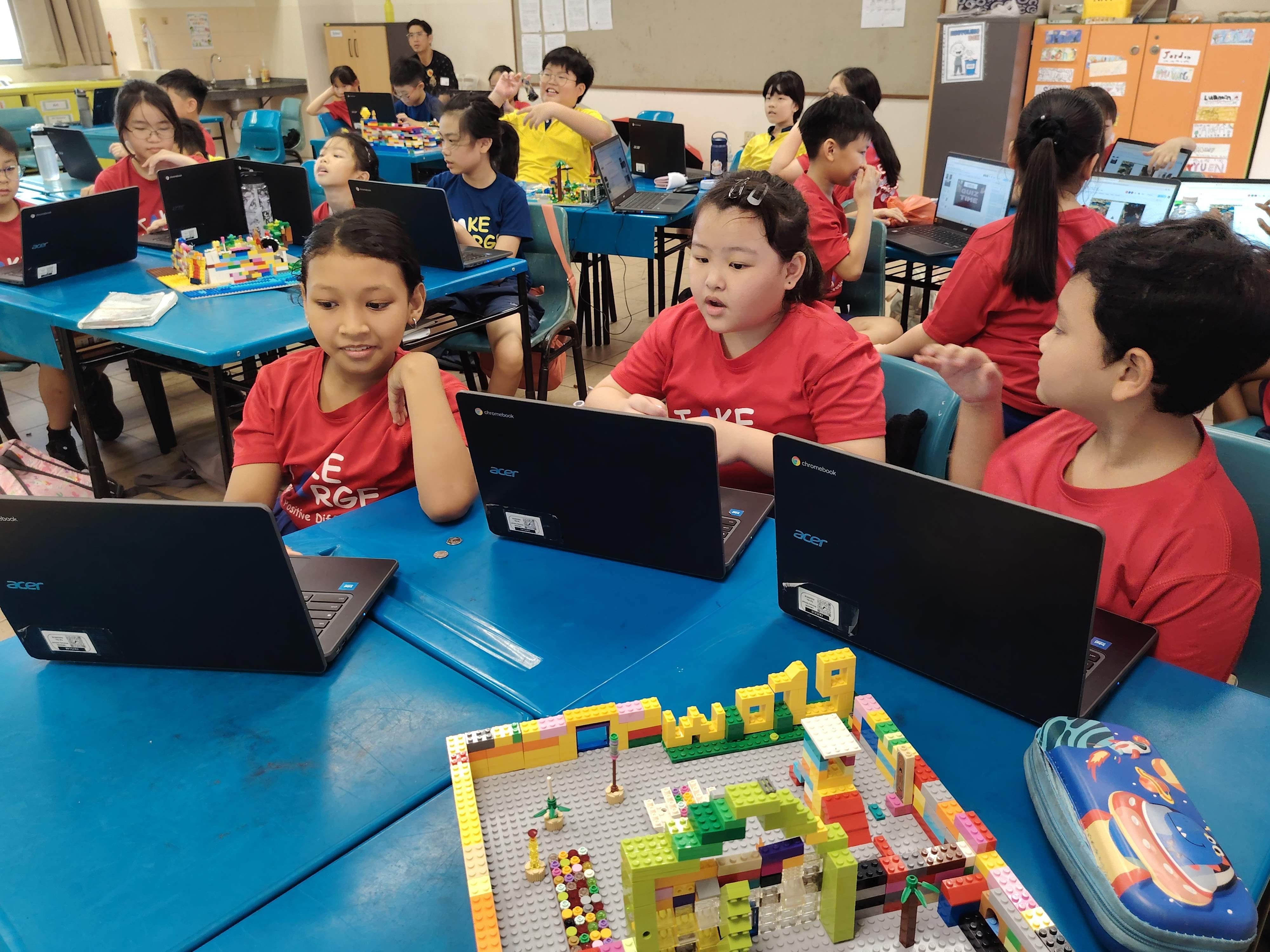 Students work together in their group on creating their presentation slides